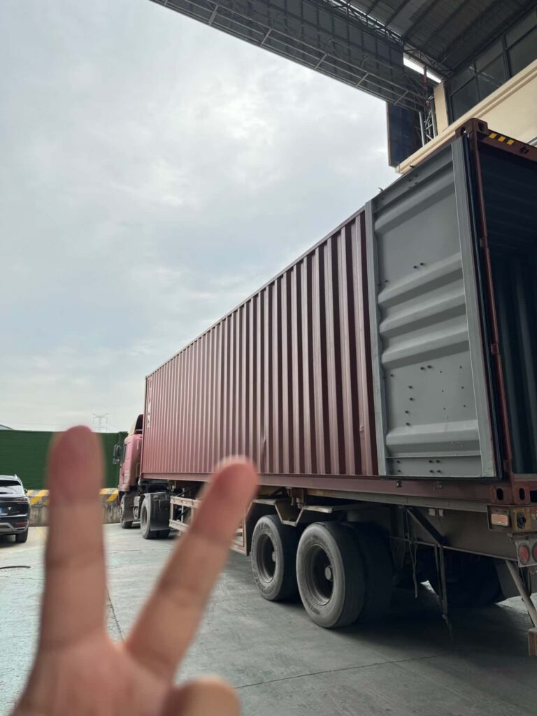 Full container load truck arriving at factory loading dock for garment export shipment