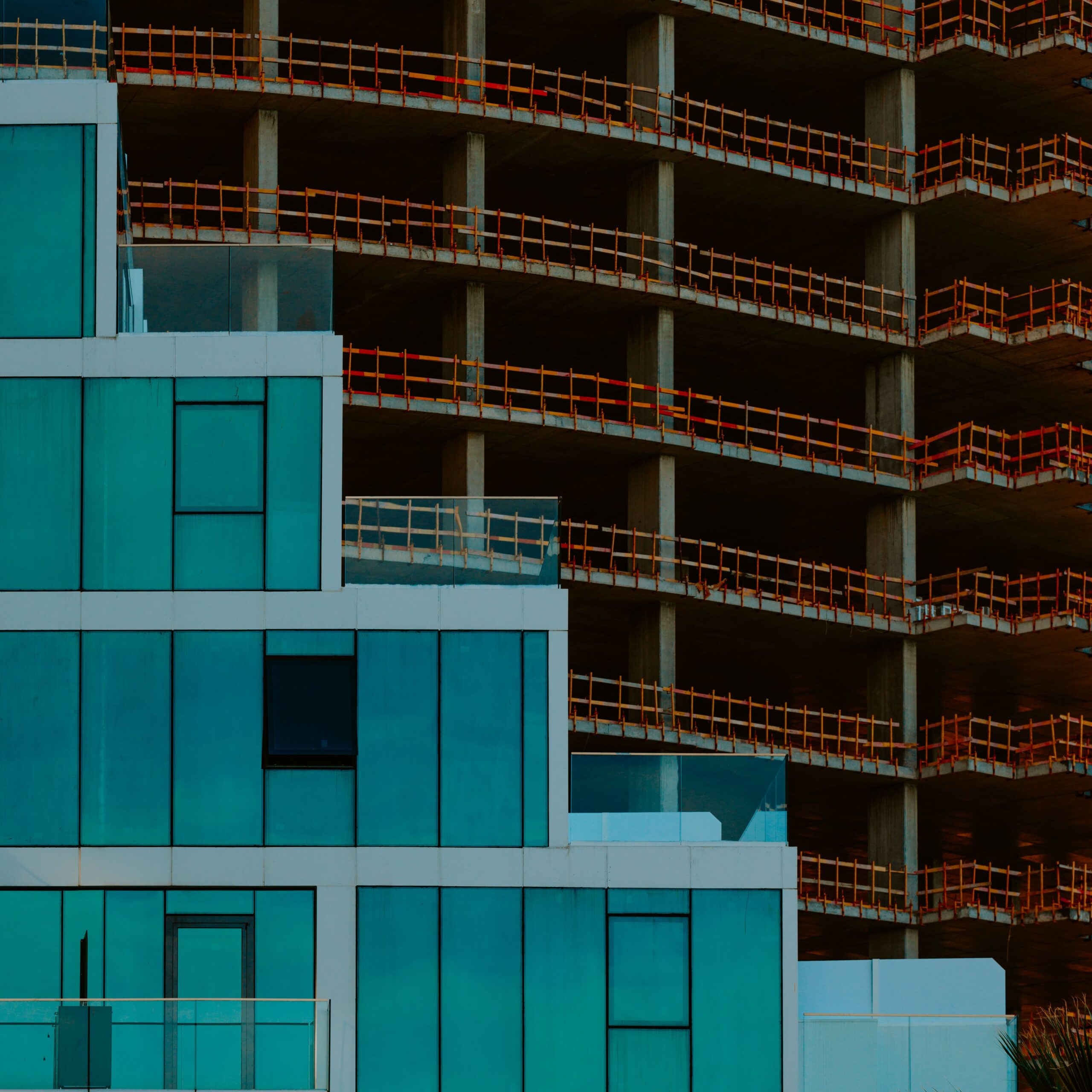Modern glass architectural facade under construction, innovative design and engineering for factory production line facilities