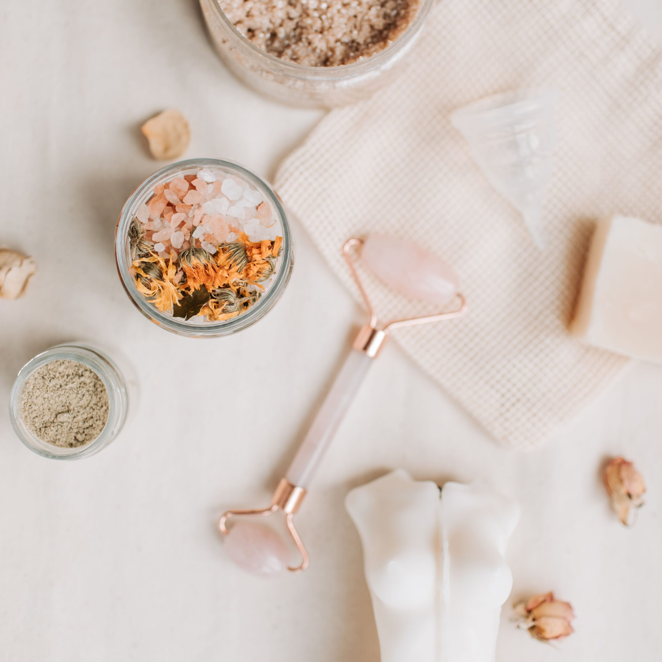 Spa essentials flat lay with jade roller and bath salts, premium wellness products from factory production line