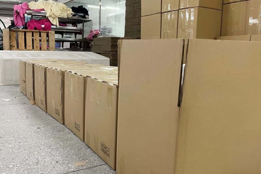 Stacked export cartons in garment factory warehouse ready for international shipping